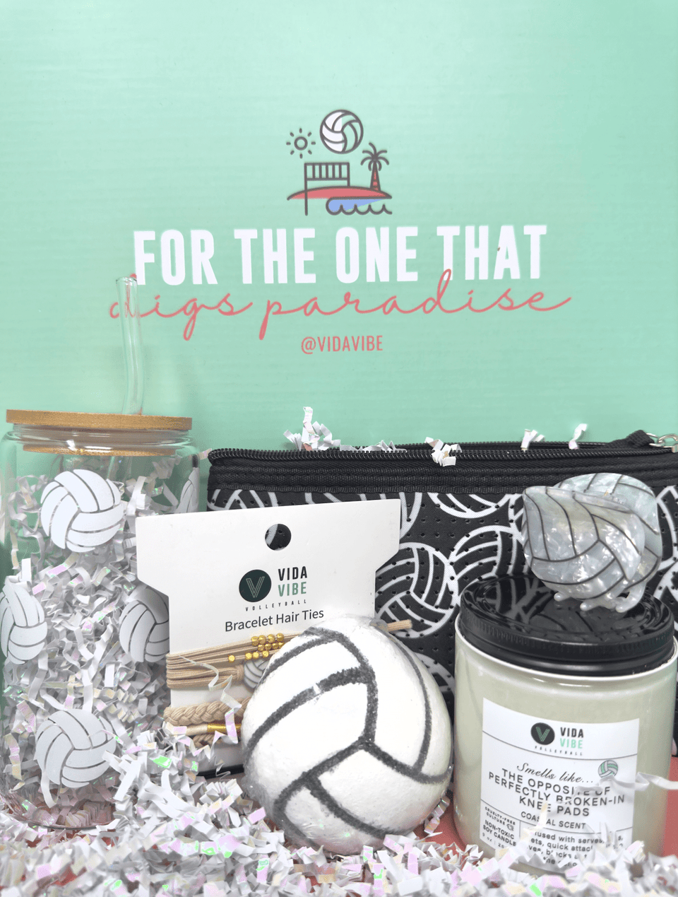 Gift set with beach-themed items on a light green background, featuring the brand 'Vida Vibe'.